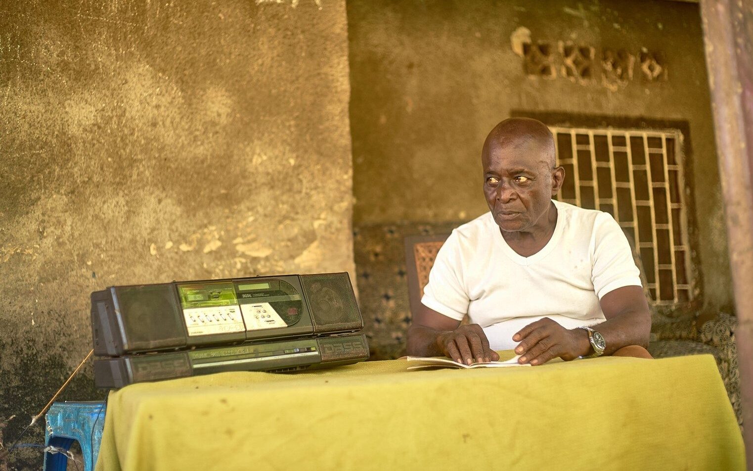 Elderly man listening to EBO-SURSY Radio in DRC